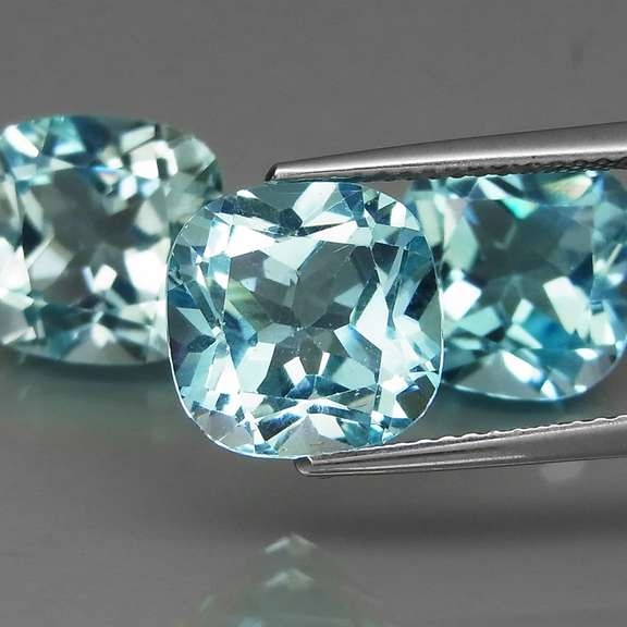 Large 16.62ct vivid blue cushion cut Topaz set
