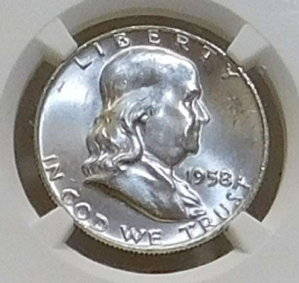 1958-D Sil Franklin Hf NGC MS-64-FBL near GEM.   NOTE:  The horozontal lines on the Liberty Bell, on the reverse,  are the high-points of the coin.  Consequently, only a very small percentage of examples show continuous and uninterrupted grooves (Full Bell Lines; FBL) on every line.  Hence, the designation acknowledges the rarity and expanded value.