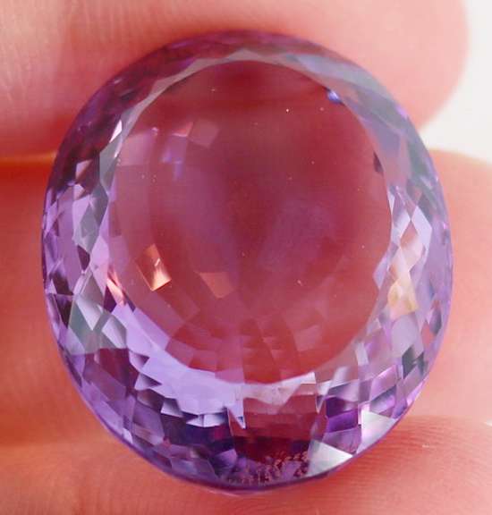 Substantial oval cut 48.27ct violet Amethyst