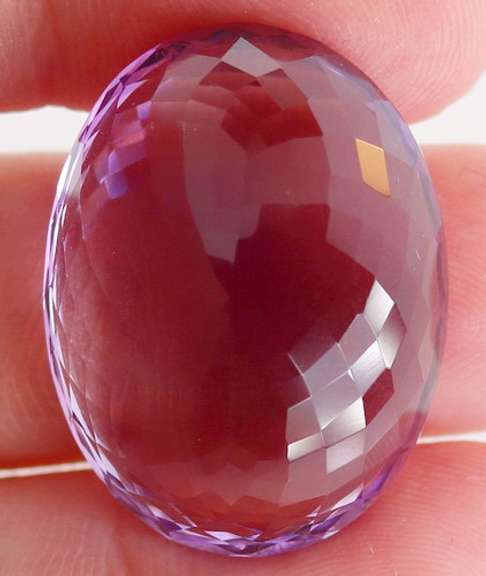Substantial oval cut 48.27ct violet Amethyst