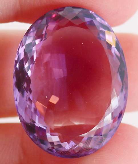 Substantial oval cut 48.27ct violet Amethyst