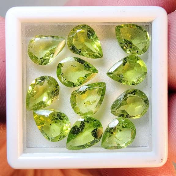 Pear cut 11 piece Peridot set weighing 10.80cts