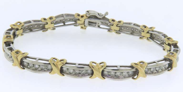14k white and yellow gold ladies diamond bracelet xo design