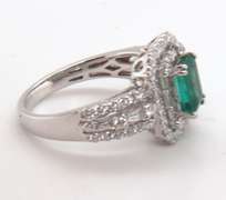 Beautifully Intricate Emeral Ring Engulfed in Diamonds with an 18k Stamped White Gold Band