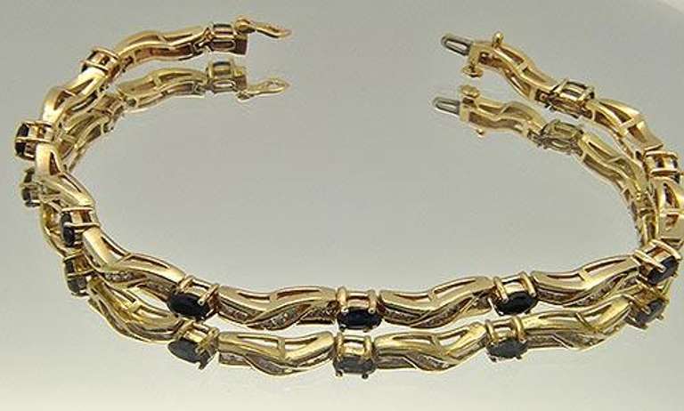 LADIES 14 KT YELLOW GOLD DIAMOND AND SAPPHIRE BRACELET.