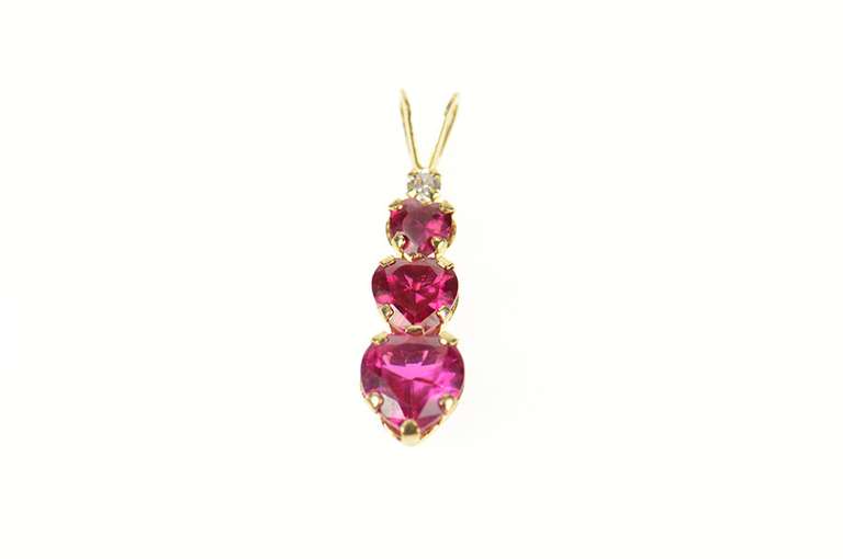 10K Yellow Gold Tiered Syn. Ruby Heart CZ Journey Symbol Pendant
