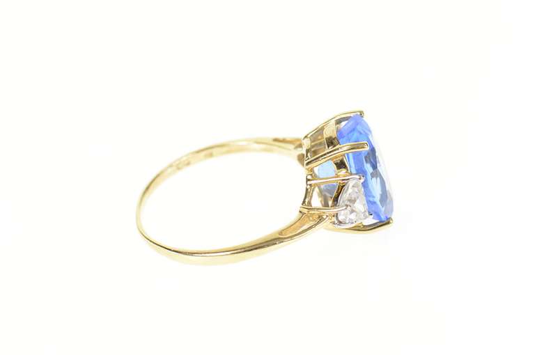 10K Yellow Gold Oval Three Stone Syn. Sapphire Trillion CZ Ring