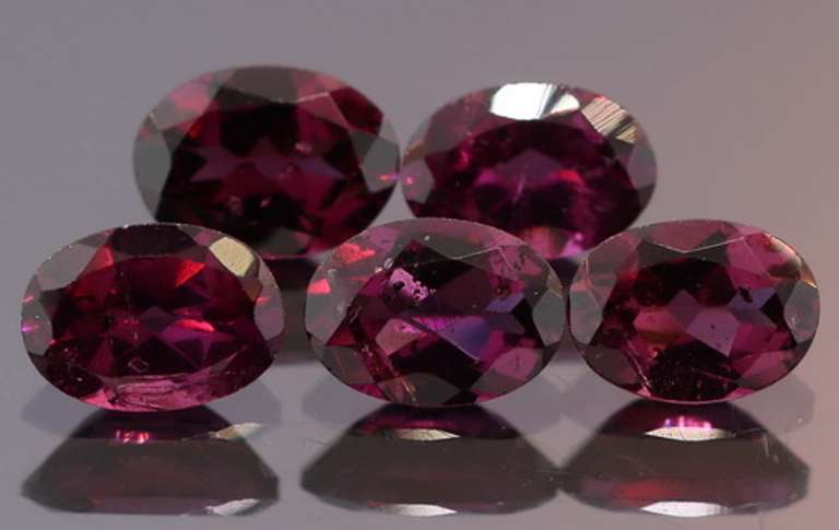 Amazing 8.74ct oval cut violet Garnet set