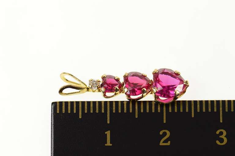10K Yellow Gold Tiered Syn. Ruby Heart CZ Journey Symbol Pendant
