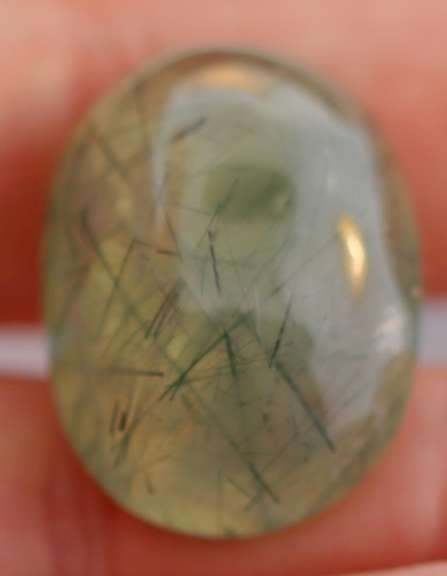 Magnificent 50.49ct deep green rutilated Prehnite cabochon