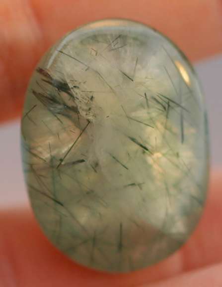 Magnificent 50.49ct deep green rutilated Prehnite cabochon