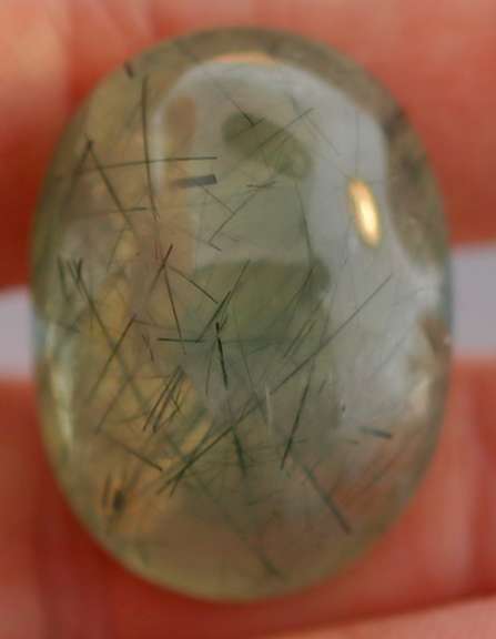 Magnificent 50.49ct deep green rutilated Prehnite cabochon