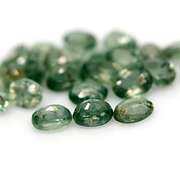 Heated only! 10.11ct oval cut green Sapphire set