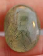 Magnificent 50.49ct deep green rutilated Prehnite cabochon