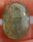 Magnificent 50.49ct deep green rutilated Prehnite cabochon