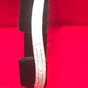 LADIES 14K WHITE GOLD AND DIAMONDS TWISTED DESIGN BANGLE BRACELET.