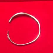 LADIES 14K WHITE GOLD AND DIAMONDS TWISTED DESIGN BANGLE BRACELET.