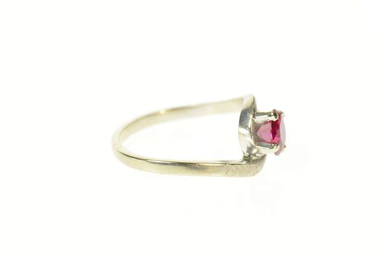 14K White Gold Round Syn. Ruby Solitaire Wavy Bypass Ring