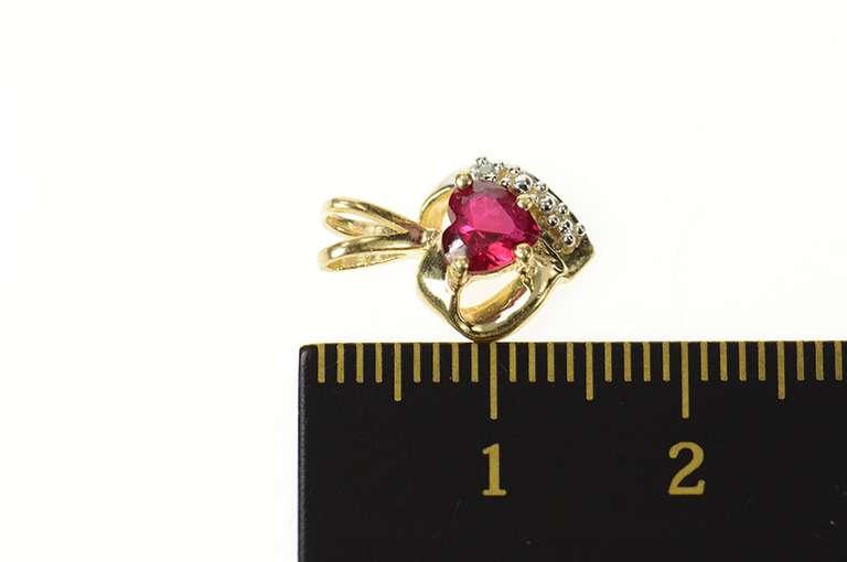 10K Yellow Gold Heart Syn. Ruby Diamond Accent Love Symbol Pendant