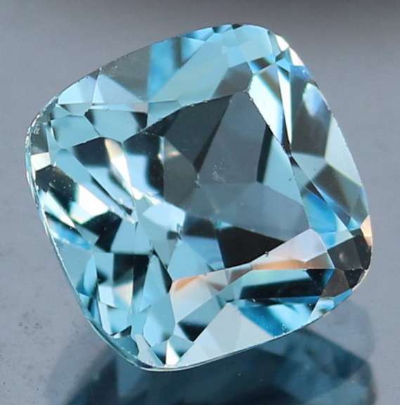 Captivating 9.17ct 12mm high fire cushion cut Topaz