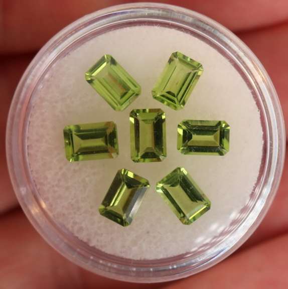 Brilliant 4.69ct 7pc set of matched emerald cut Peridot