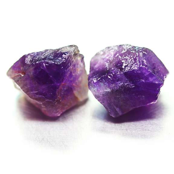 Collectors rich untreated 19.68ct uncut Amethyst pair