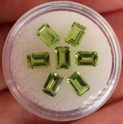 Brilliant 4.69ct 7pc set of matched emerald cut Peridot