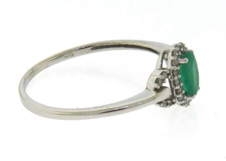 Charming Oval Emerald and Diamond Halo Ring