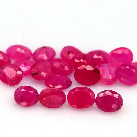 Vibrant 6.65ct oval cut reddish pink Ruby set