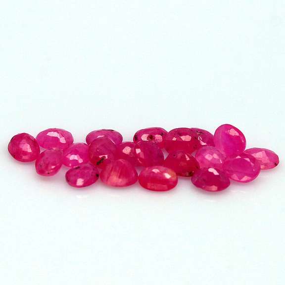 Vibrant 6.65ct oval cut reddish pink Ruby set