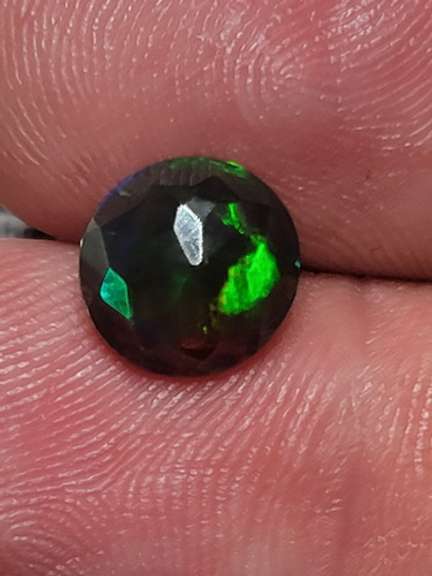 Smoldering 1.54ct round cut Welo black Opal