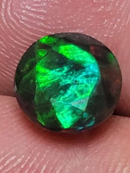 Smoldering 1.54ct round cut Welo black Opal