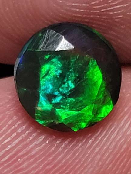 Smoldering 1.54ct round cut Welo black Opal