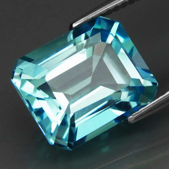High fire vivid blue 7.58ct emerald cut Brazilian Topaz