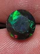 Smoldering 1.54ct round cut Welo black Opal