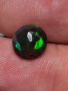 Smoldering 1.54ct round cut Welo black Opal