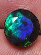 Smoldering 1.54ct round cut Welo black Opal