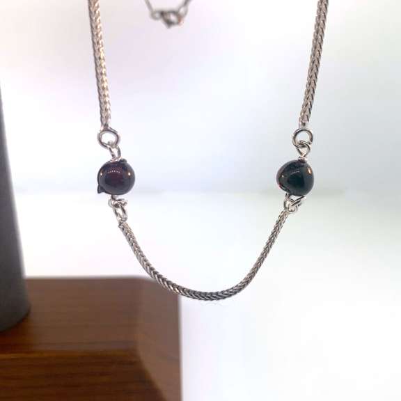 Sterling silver necklace with red beads.