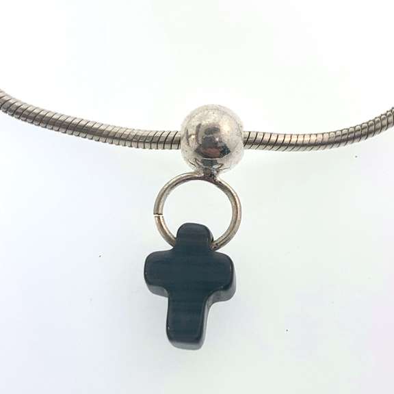 Sterling silver bracelet with one silver bead and a grey/black cross charm