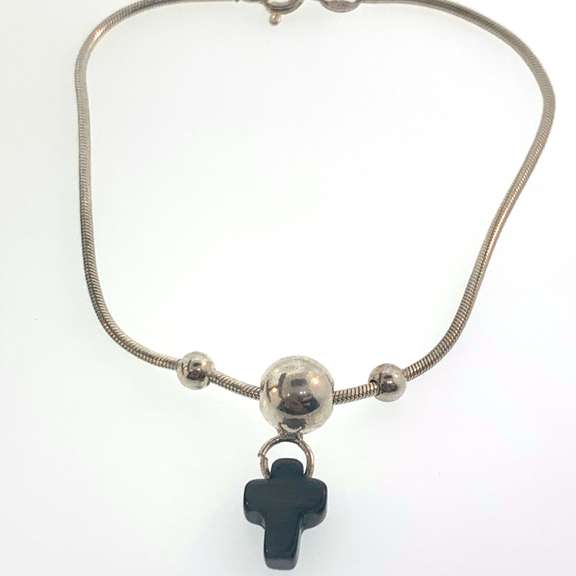 Sterling silver bracelet with three silver bead and a grey/black cross charm