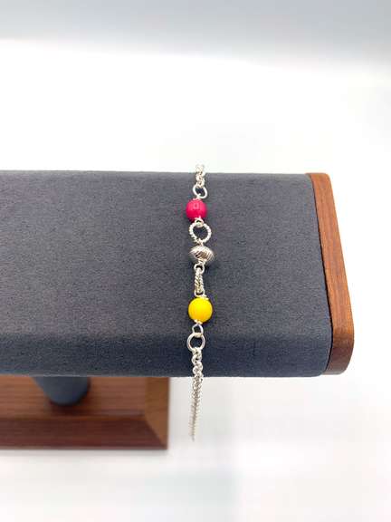 Sterling silver bracelet with yellow, pink, and silver beads.