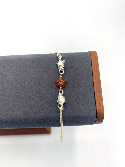 Sterling silver bracelet with orange & silver star charms