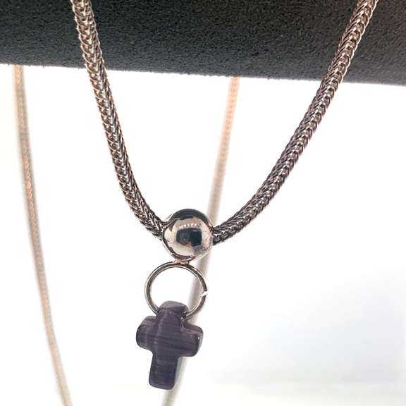 Sterling silver necklace with a purple cross charm and silver beads