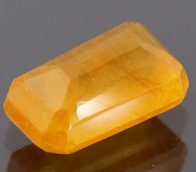 Vibrant 4.29ct emerald cut orange Sapphire