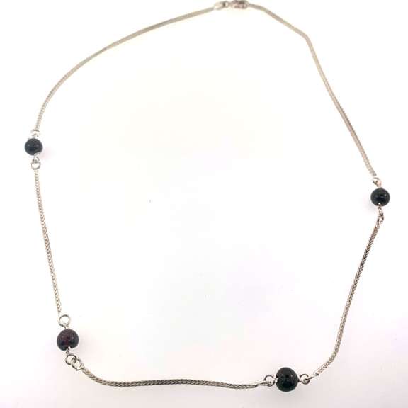 Sterling silver necklace with red beads.