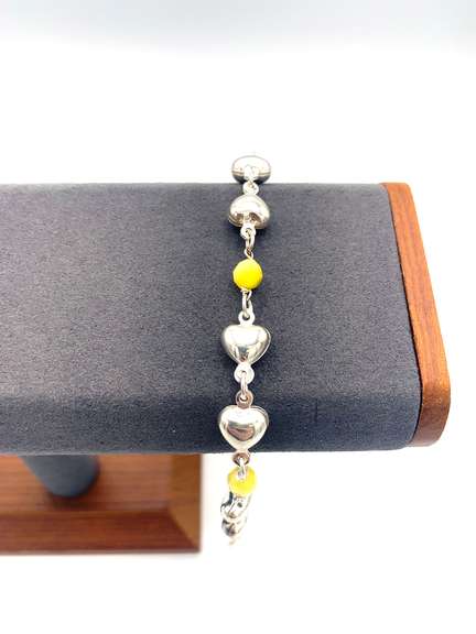 Sterling silver bracelet with yellow beads and silver heart charms