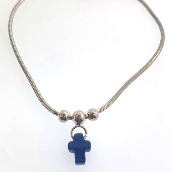 Sterling silver bracelet with three silver beads and one blue cross charm