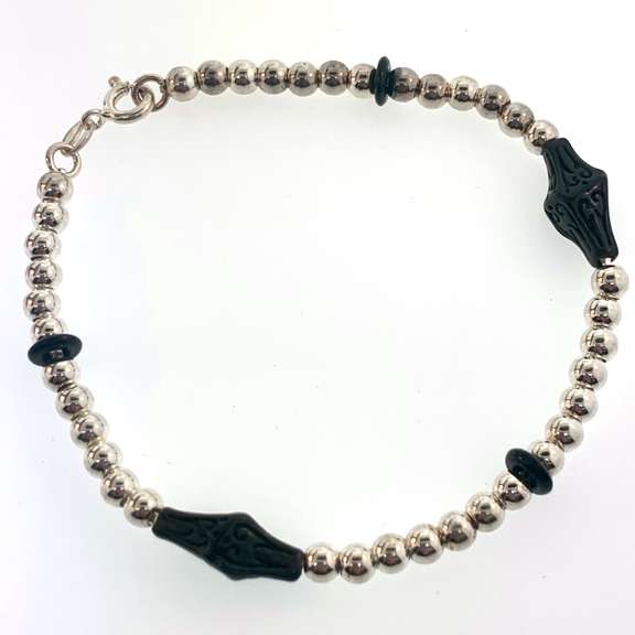 Sterling silver bracelet with silver beads and unique black charms