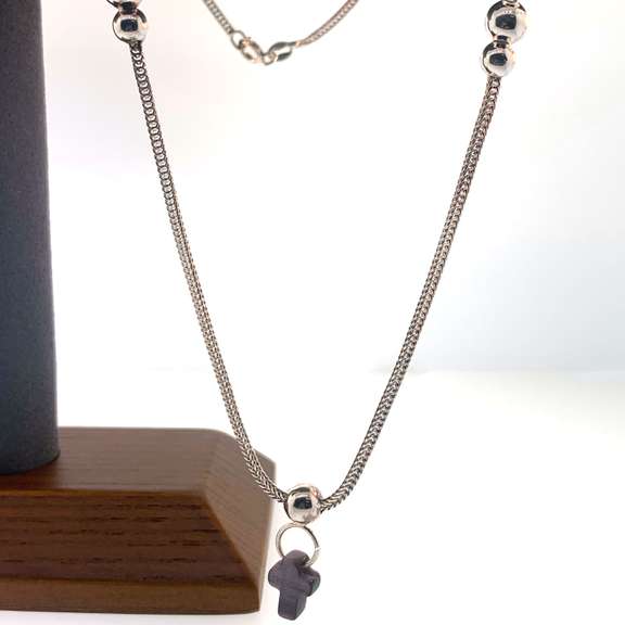 Sterling silver necklace with a purple cross charm and silver beads