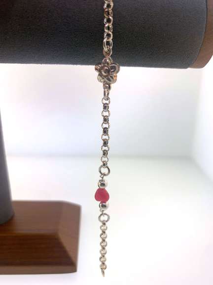 Sterling silver bracelet with pink heart beads and a flower charm